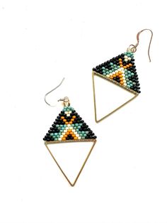 These earrings were hand woven using a brass triangle frame and glass seed beads to create a tribal pattern. Each earring is 2.5 inches long.  These earrings hang from 14k gold filled ear wires. Triangle Frame, Seed Bead Jewelry Patterns, Beaded Earring, Loop Earrings, Triangle Pattern, Triangle Earrings, Bead Jewelry, Seed Bead Jewelry, Jewelry Patterns