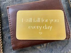 a wallet with a card holder that says, i still fall for you every day