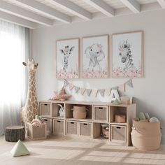 a baby's room with two giraffes on the wall