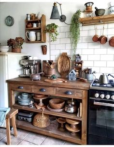 a kitchen with lots of pots and pans on the stove top in front of an oven