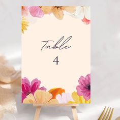 a table number card with flowers on it