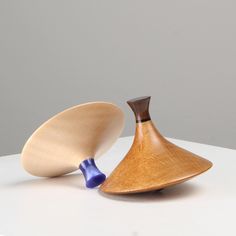 two wooden vases sitting on top of a white table