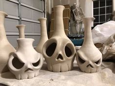 five vases with different shapes and sizes on a table