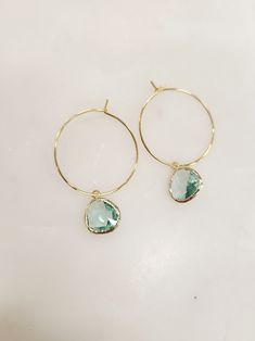 Our easy to wear gemstone hoop is the perfect choice to for any occasion. So simple yet so elegant. Customize your color to match any outfit you have! Hoop is 1 3/4" round Glass teardrop gemstone is 1/2"W x 5/8"L 14K yellow gold filled over sterling silver or sterling silver. Lead and nickel free (zinc is used in place of nickel). **Born in 2008 from a mother, daughter team looking to create an affordable, USA made line** Blue Bohemian Hoop Earrings With Natural Stones, Blue Gemstone Hoop Earrings, Elegant Gold-plated Gemstone Hoop Earrings, Blue Gold Earrings, Light Blue Gemstone Round Earrings, Blue Nickel-free 14k Gold-filled Hoop Earrings, Gemstone Hoop Earrings, Gem Earrings, Mother Daughter