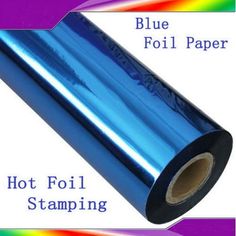 a roll of blue foil sitting on top of a rainbow colored tablecloth with the words hot foil stamping below it