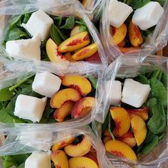 four plastic bags filled with fresh fruit and cheese