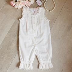 This Baby Girl's White Vintage Romper Is One Of The Most Precious Things I Have Seen In Baby Clothing!! Also Know As A "Camaloon". The Outfit Is Done In A Fine 100% Cotton Lawn In A Soft-White Hue. The Arms Openings And Neckline Are Trimmed In A Matching Cotton Crocheted Lace. The Shoulders Have Button Closures (Another Sweet Feature), Where The Crocheted Trim Wraps The Entire Strap. The Chest Has 4 Mid-Size Pintucks/Pleats With Crocheted Cotton Lace In Between. A Front Button Placket Has The Cr Cotton Fitted Bloomers For Playwear, Fitted Cotton Bloomers For Playwear, Cotton Bloomers For Playwear, White Cotton Bloomers For Playwear, White Bloomers For Spring Playwear, Spring White Bloomers For Playwear, Vintage Romper, Cotton Crochet, Mother Of Pearl Buttons