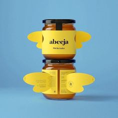 two honey jars with labels on them sitting side by side against a blue background that says albeja