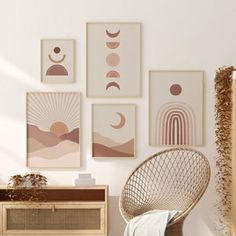 a room with pictures on the wall and a wicker chair in front of it