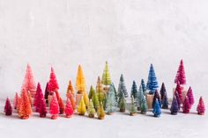 there are many small trees made out of colored crayons