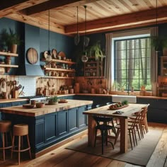 a kitchen with blue walls and wooden floors, an island in the middle is surrounded by potted plants