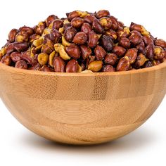 a wooden bowl filled with lots of nuts