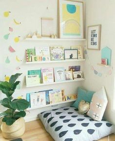 a child's room with bookshelves and toys on the shelves above it