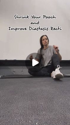 a woman is sitting on the floor doing yoga