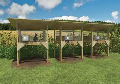 three wooden structures with plants growing in them on the grass and blue sky above it