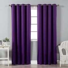 the purple curtains in this room are ready to be hung