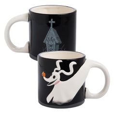 two black and white coffee mugs with designs on the sides, one has a ghost