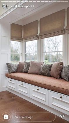 a window seat with many pillows on it