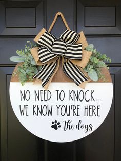 a door hanger that says, no need to knock we know you're here the dogs