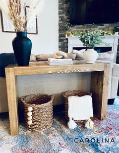 a living room with a couch, table and two baskets