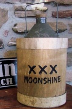 an old fashioned wooden lantern sitting on top of a table