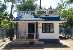 a small white house with a blue roof