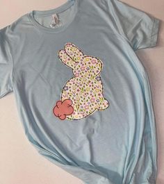 a blue t - shirt with an image of a bunny on it