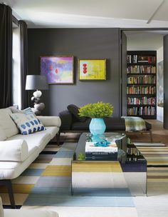 a living room filled with furniture and bookshelves