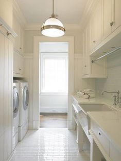 an image of a white house with the door open and washing machine in front of it