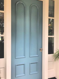 a blue front door on a white house