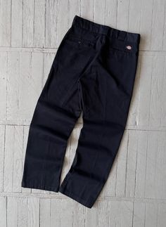 FOLLOW MY SHOP TO CHECK DAILY UPDATES & PRICE DROPS Vintage Dickies Minimalist Work Pants in Black Relaxed fit. Wide leg. 5 pocket design. Patch with Dickies logo on the backpocket Size 32x32 Waist (1/2) - 16'' Length - 29'' Leg Opening - 8.5'' Pants are in very good pre-owned condition. Please check pictures for more information on the product Shipping options: - standard shipping in 7-15 days - priority in 3-5 business days (price will be more)   Check out my other items & follow - new arrivals every week! If you have any questions regarding the item, shipping - feel free to contact any time. All items are genuine. Customer satisfaction is our priority! Classic Streetwear Pants With Standard Cut Leg, Classic Streetwear Pants With Standard Cut, Classic Work Pants With Pockets For Streetwear, Classic Cotton Work Pants For Streetwear, Classic Black Cotton Work Pants, Classic Black Cargo Pants For Work, Black Relaxed Fit Work Pants, Classic Black Cotton Pants, Relaxed Fit Work Pants With Standard Cut Leg