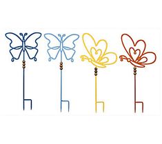 four different colored butterfly shaped garden stakes on white background with clipping for text