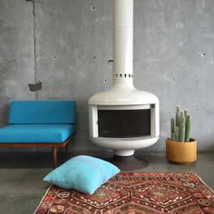 a white stove sitting next to a blue couch