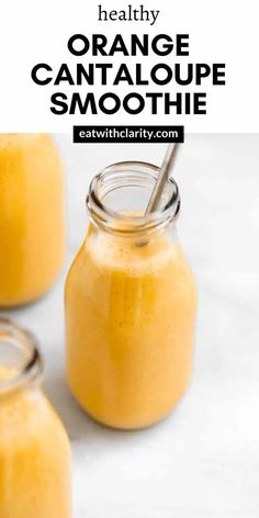 three jars filled with orange cantaloupe smoothie on top of a white counter