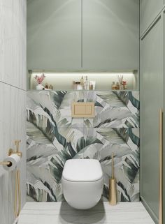 the bathroom is decorated with tropical wallpaper and white fixtures, along with gold accessories