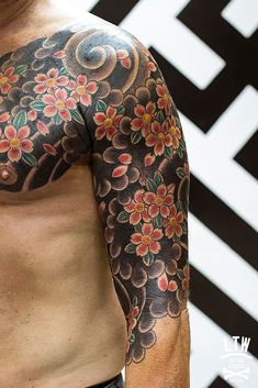 a man with tattoos on his arm and chest