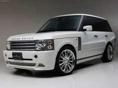 a white range rover is parked in a room