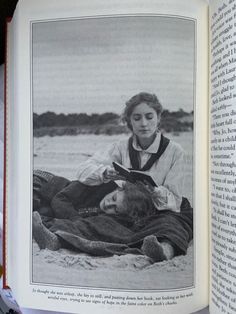 an open book with a black and white photo of a woman laying on the beach