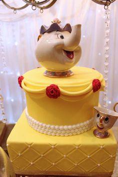 a beauty and the beast cake with an elephant figurine on top