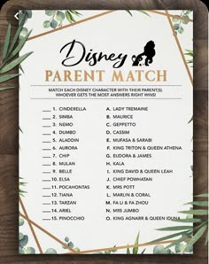 the disney parent match game is shown on a wooden table with greenery around it