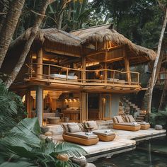 a house that has some couches on the porch near it and trees in the background