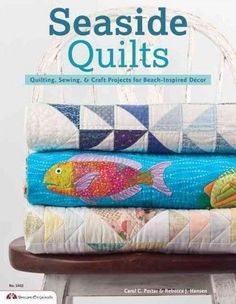 the cover of seaside quilts, featuring three colorful fish on top of each other