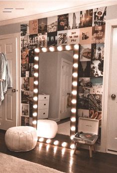 a bedroom with a large mirror and lights on the wall