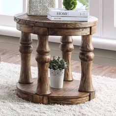 a wooden table sitting on top of a white rug next to a potted plant