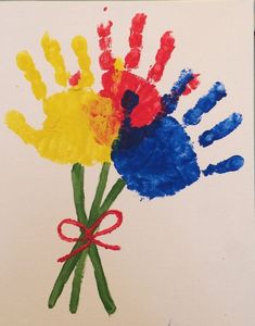 two handprints with different colors on them and tied in red, yellow, blue, and green