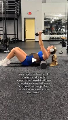 a woman is doing an exercise in the gym