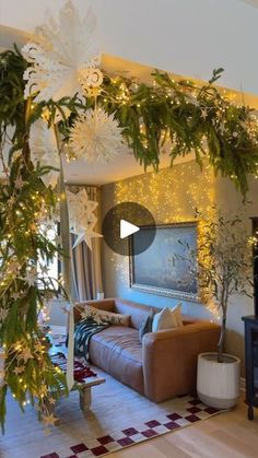 the living room is decorated for christmas with white flowers and greenery hanging from the ceiling