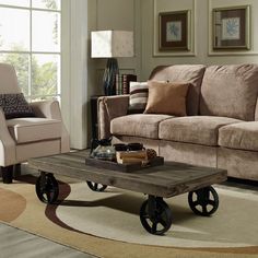 a living room with a couch, chair and coffee table in front of a window