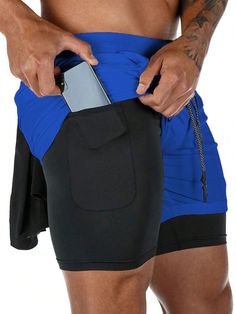 a man is holding his cell phone in his pocket while wearing blue and black shorts