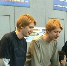 two young men standing next to each other